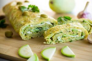 vegetable zucchini roll with garlic cheese filling inside. photo