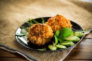 Cooked meatballs in a plate with fresh vegetables photo