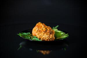 Cooked meatballs in a plate with fresh vegetables photo