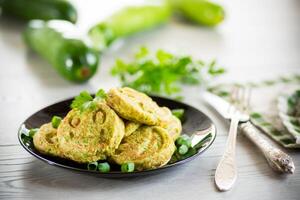 Fried squash green pancakes in a plate. photo