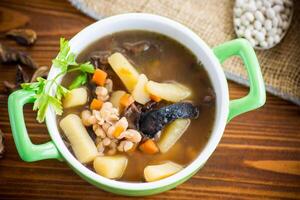 mushroom hot soup with beans in a bowl photo