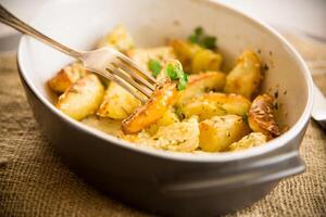 potatoes baked with sesame seeds, herbs and spices in the oven photo