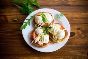 fried in batter sandwiches with tomatoes and mozzarella in a plate with herbs photo