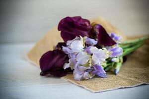 bouquet of beautiful blooming iris flowers on wooden background photo