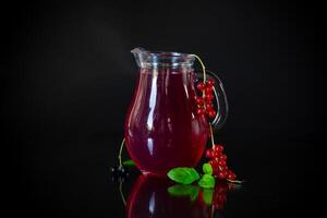 Cold refreshing drink from fresh summer berries in a decanter. photo