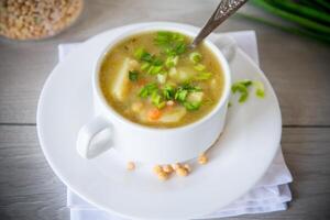 dried pea soup in a plate with herbs photo