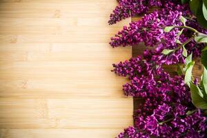 The beautiful lilac on a wooden background photo