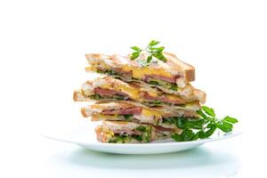 fried toasts stuffed with sausage, cheese and greens inside, on white background. photo