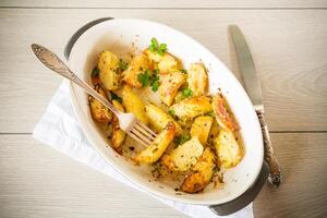 potatoes baked with sesame seeds, herbs and spices in the oven photo