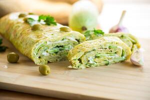 vegetable zucchini roll with garlic cheese filling inside. photo