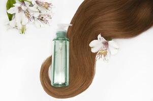 Cosmetic hair oil on a white background. Hair care. Healthy and beautiful hair. Copy space for text photo
