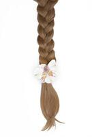 Beautiful braided hair with a white flower. photo