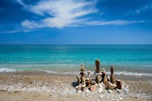 Concept of balance and harmony - pebble stone stacks on the beach photo