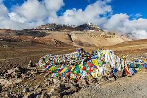 Buddhist prayer flags lungta on Baralacha La pass in Himalayas photo