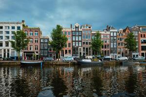 Singel canal in Amsterdam with houses. Amsterdam, Netherlands photo