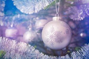 Christmas-tree decoration bauble on decorated Christmas tree bac photo