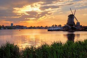 Windmills at Zaanse Schans in Holland on sunset. Zaandam, Nether photo