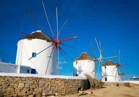 Traditional greek windmills on Mykonos island at sunrise, Cyclades, Greece photo