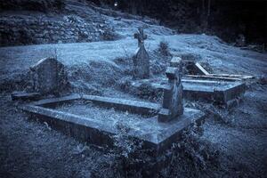 Spooky Halloween graveyard in fog photo