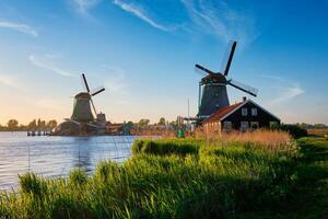 Windmills at Zaanse Schans in Holland on sunset. Zaandam, Netherlands photo