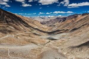 View of Karakoram range and road in valley in Himalayas photo