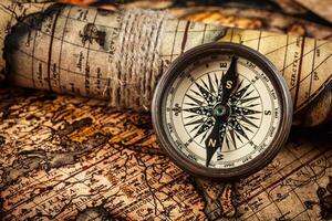 Old vintage compass on ancient map photo