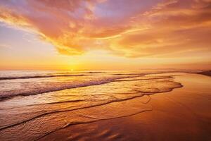 Atlantic ocean sunset with surging waves at Fonte da Telha beach, Portugal photo