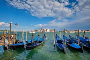 Gondolas and in lagoon of Venice by San Marco square. Venice, Italy photo