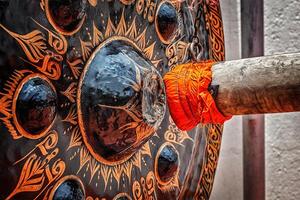 Mallet beating gong in Buddhist temple photo