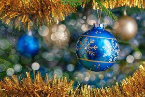 Christmas-tree decoration bauble on decorated Christmas tree bac photo