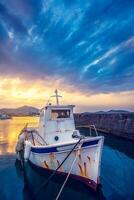 Old fishing boat in port of Naousa on sunset. Paros lsland, Greece photo