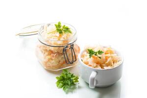 Sauerkraut with carrots and spices in a glass jar photo