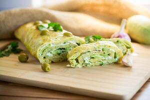 vegetable zucchini roll with garlic cheese filling inside. photo