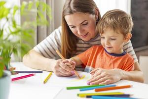 Mother and her son drawing together photo