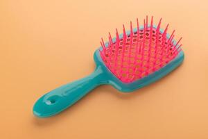 Colorful Hair Brush on Orange Background photo