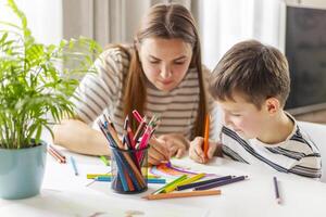 Mother and her son drawing together photo