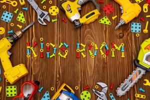 Colorful toy tools as frame with text Kids Room on wooden background photo