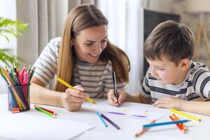 Mother and her son drawing together photo