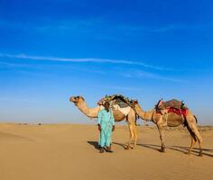 Cameleer camel driver camels in Rajasthan, India photo