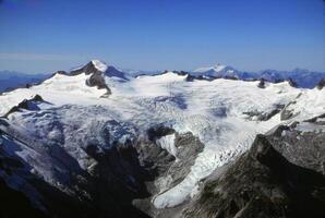 Steep mountain peaks and glaciers photo