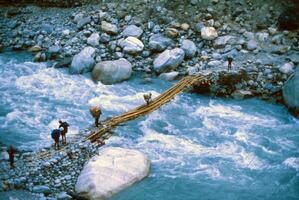 Crossing a suspension bridge over the Kali Gandaki photo