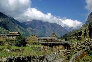 Chortens and porter carrying load photo