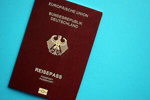 rojo alemán pasaporte de europeo Unión en azul antecedentes cerca arriba foto
