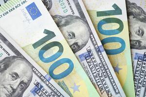 KYIV, UKRAINE - FEBRUARY 28, 2024 US Dollar and EU Euro money bills in fan layout. Different popular currencies photo