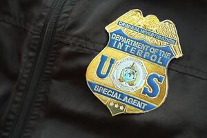 KYIV, UKRAINE - MARCH 9, 2024 US Interpol Special Agent badge on black jacket uniform photo