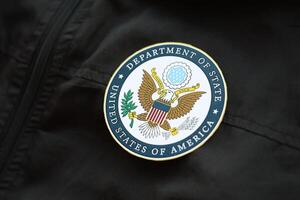 KYIV, UKRAINE - MARCH 9, 2024 US Department of State seal on black jacket uniform photo