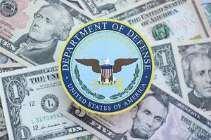 KYIV, UKRAINE - MARCH 9, 2024 US Department of Defense seal on many US dollar bills photo