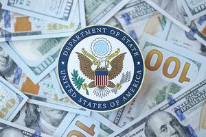 KYIV, UKRAINE - MARCH 9, 2024 US Department of State seal on many US hundred dollar bills photo