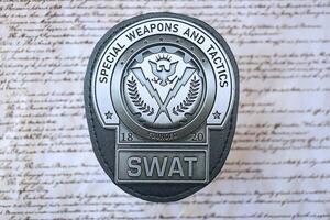 KYIV, UKRAINE - MARCH 9, 2024 US SWAT badge on United States Constitution photo