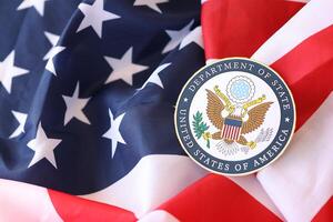 KYIV, UKRAINE - MARCH 9, 2024 US Department of State seal on United States of America flag photo
